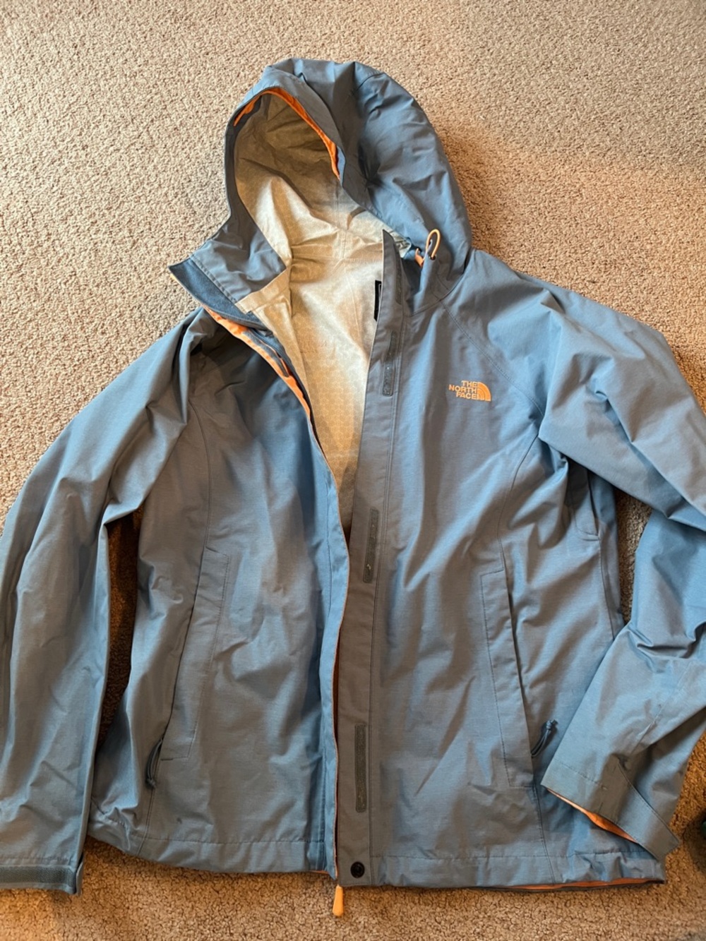 The North Face women’s Slate Blue Hooded Rain Jacket with Orange Accents